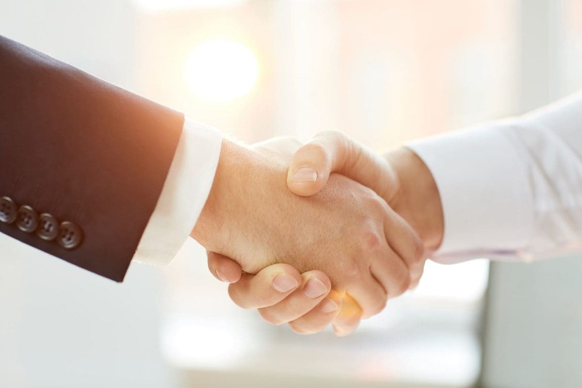 Business partners shaking hands after negotiation